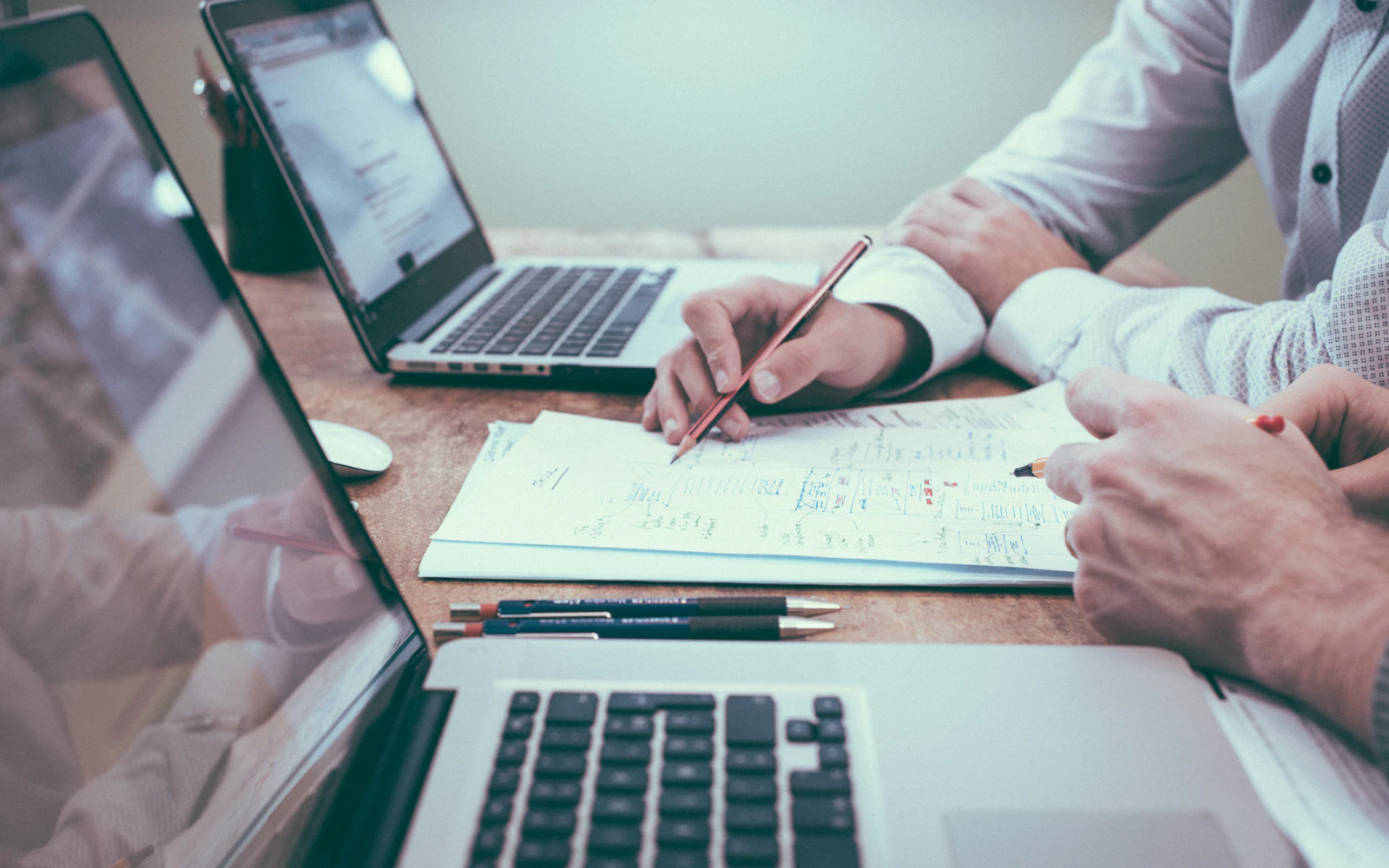 Finance professionals reviewing bookkeeping records and financial data